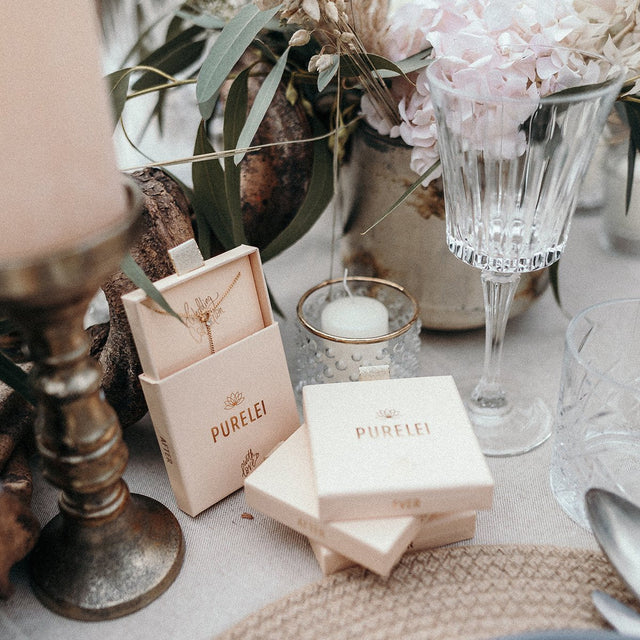 PURELEI Kekahi Armband in 18K Gold vergoldetem Edelstahl, zwei ineinandergreifende Ringe auf feinem Leinentisch