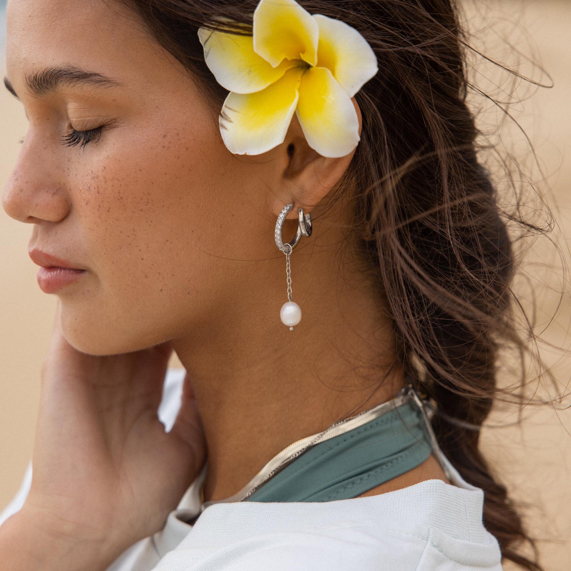Silberne Ohrringe mit Perle und Glitzerdetails, PURELEI, in tropischer Stimmung.